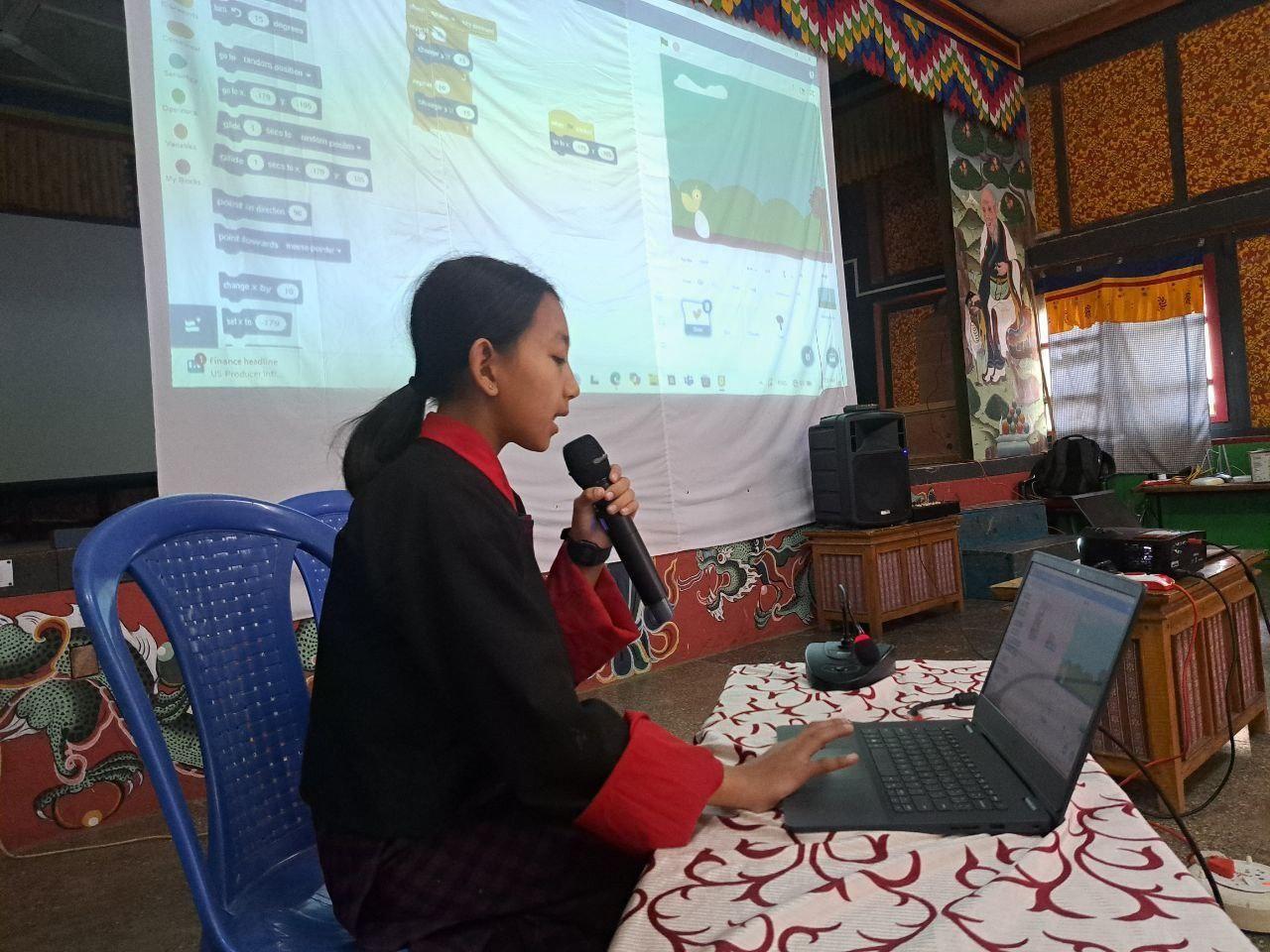 A student presents her project at the regional coding exhibition, October 2024
